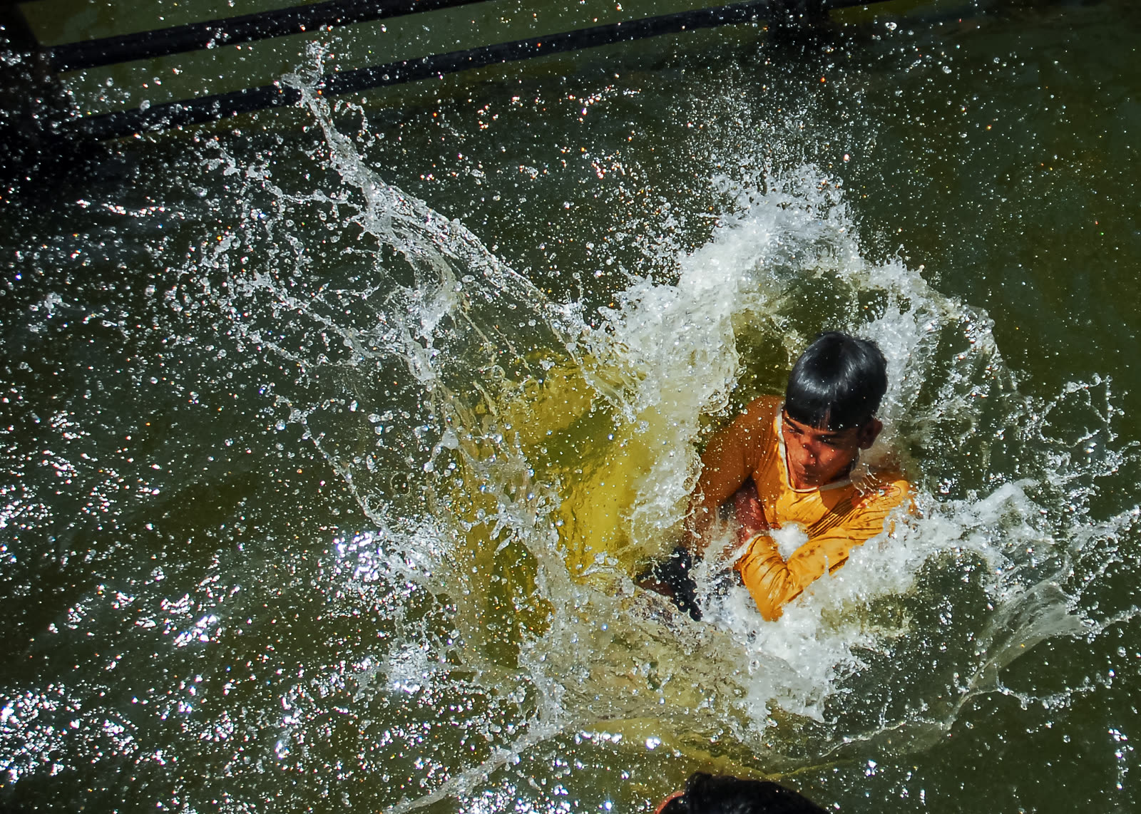 A boy captured mid-splash
